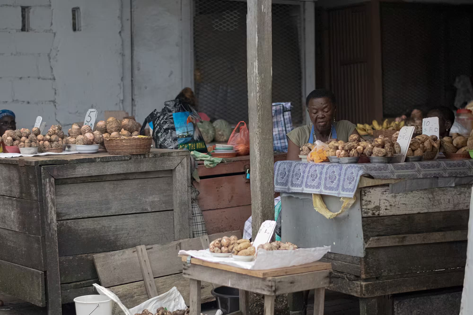 photo of lady on the market selling food
